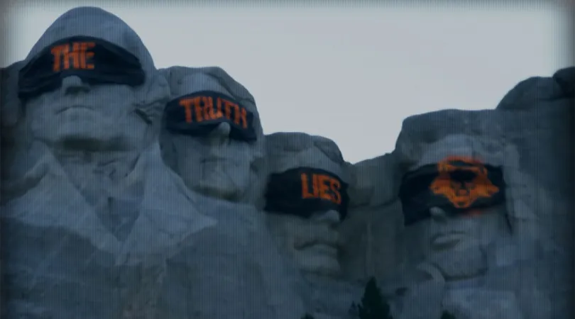 Image of Mount Rushmore covered in banners that read The Truth Lies. The final banner is a Project Cerberus logo, the logo for Call of Duty Black Ops 6