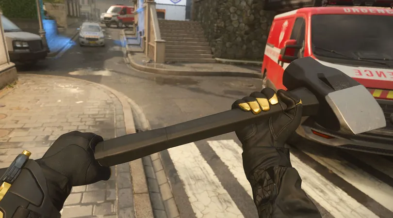 Modern Warfare 3 player holding sledgehammer with red van and tram rails in background
